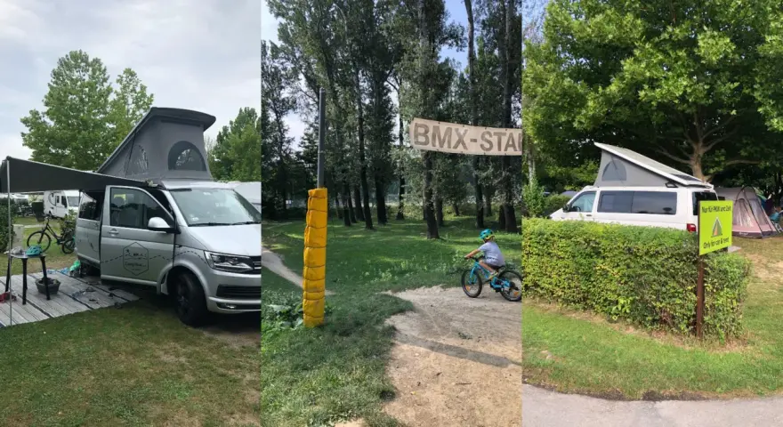 Kamper i rowerowy tor BMX na kempingu w Wiedniu. Dziecko na rowerze, baner "BMX-STAR".